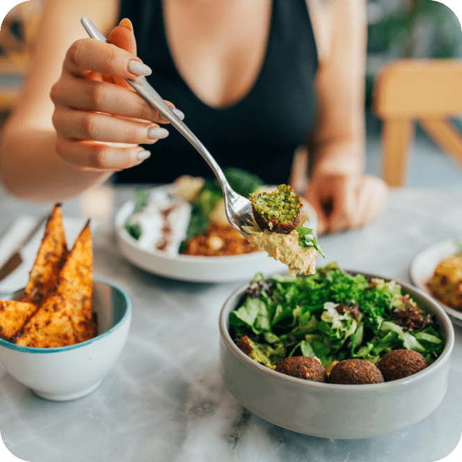 Person eating a falafel bowl